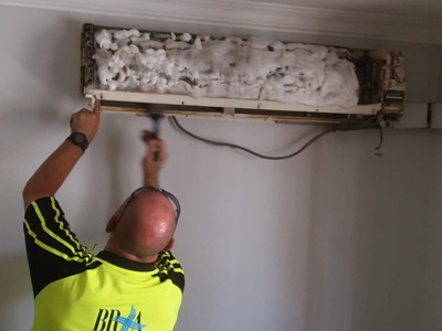A split system air conditioner in home being serviced.