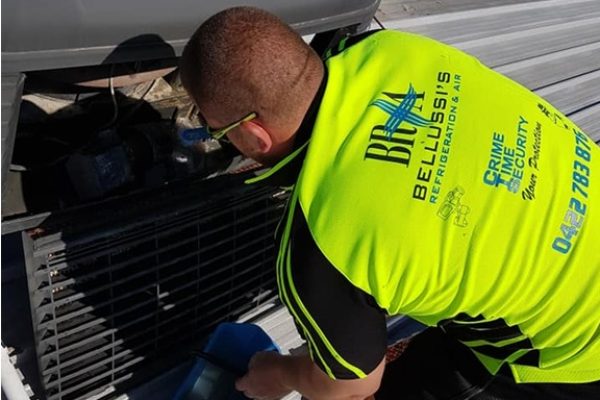 One of the Bellussi Air team servicing an evap aircon on roof.